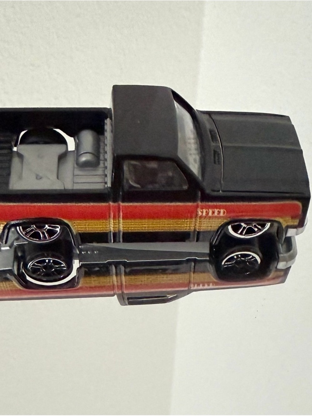 Black Toy Pickup Truck with Red and Yellow Stripe. New without box